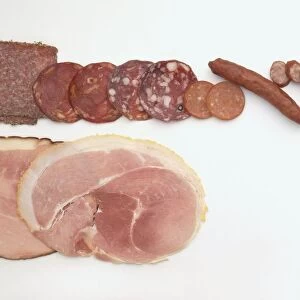 Slices of cooked ham, and different types of salami and cured sausage (kabanos)