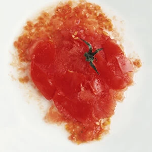 Squashed tomato on a plate, view from above