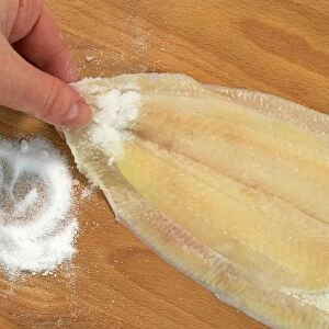 Using salt to get a firm grip on fish fillet, skin-side down, before skinning