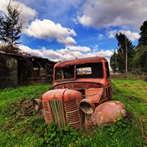 Old rusty truck half buried