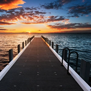 A pier leading to the sunset