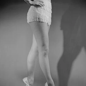 Ballet dancer standing on tiptoes, low section