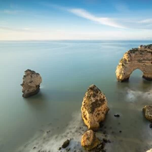 Cliffs framed by turquoise water Praia da Marinha Portugal