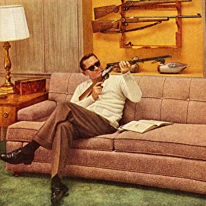 Man Wearing Sunglasses and Holding Gun