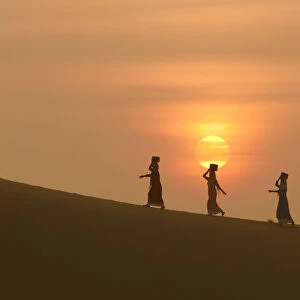 Minority Cham Girls on Sand Dune in beautiful sunsire / dawn