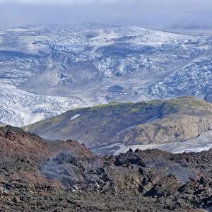 View across new lava fields created by a volcanic eruption in 2010 to the Myrdalsjokull glacier, at the long-distance hiking trail from Skogar via Fimmvorouhals to the Thorsmork mountain ridge, Porsmork, Iceland