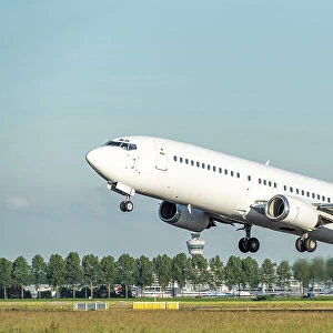 A white Boeing 737 airplane taking off