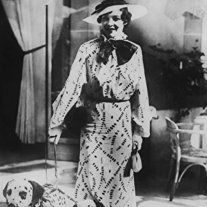 Woman with two dalmatians wearing patterned dress (B&W)