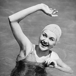Woman waving in pool (B&W), , elevated view