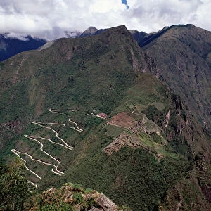 Aerial view of Machu-Picchu, Pre-Columbian 15th-century site, with the Hiram Bingham road
