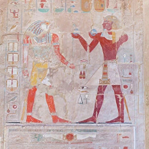 Bas relief picture depicting the pharaoh (on the right) making offerings to the God Horus, Hatshepsut temple of Deir Al Bahari, Luxor, Egypt (photo)