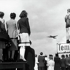 Berliners watching aeroplanes during the Berlin blockade, Tempelhof airport, 1948 (b/w photo)