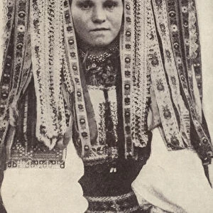 Czech woman wearing a headdress of ribbons where each ribbon denotes a suitor she refused in marriage (b / w photo)