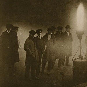 Gathering around an acetylene flare at traffic control point in the fog (sepia photo)