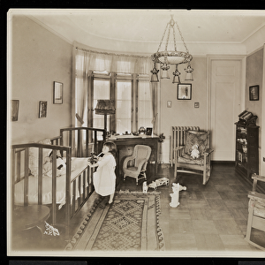 A girl holding a candle, climbing into a crib, in a bedroom of the A. C