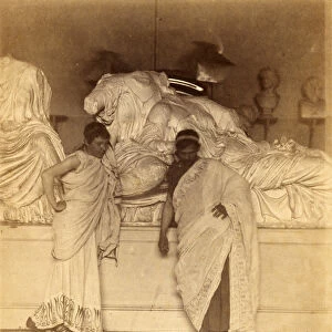 Two male students in Grecian Costume before a plaster cast of the three fates