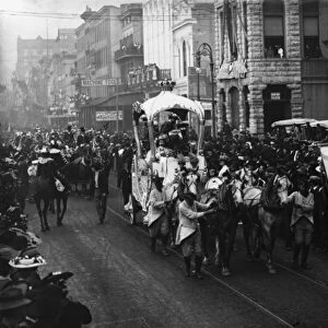 Mardi Gras day, Rex passing up Camp Street, New Orleans, c. 1900-06 (b / w photo)