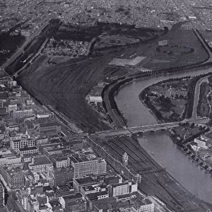 Melbourne: An aerial view of the Jolimont Railway Yards and the River Yarra, Showing a small section of the city and Richmond in the distance (b / w photo)