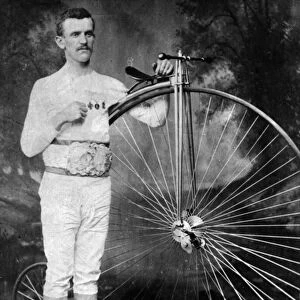 Mr George Waller wearing his Long Distance Championship belt and holding his bicycle