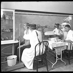 Two patients being examined in the main hospital examining room, Seton Hospital