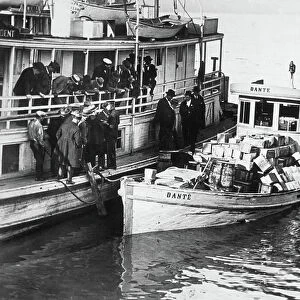 Rumrunner « Dante » anchored at the wharf with alcohol aboard and guarded by prohibition agents, New Orleans, USA, 1925 (b/w photo)