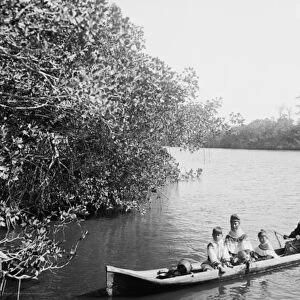 Seminole Indian and family dugout canoe, Miami, Florida, c. 1910-20 (b / w photo)