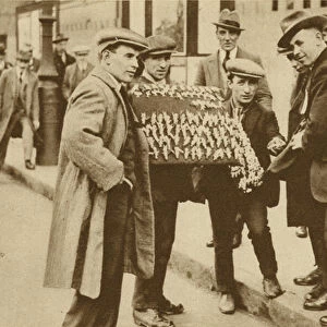 Street hawkers sell football favours at Kings Cross (b / w photo)