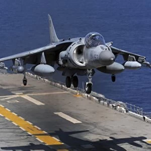 An AV-8B Harrier jet lands on the flight deck of USS Essex