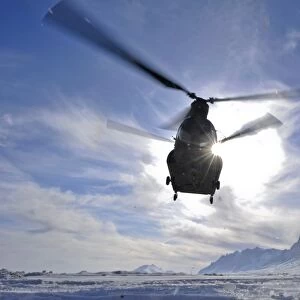 A CH-47 Chinook helicopter takes off from a remote landing zone