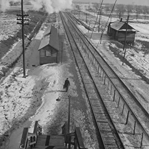 Conductor walks to the passenger station to wait for a suburban train to go home, 1943