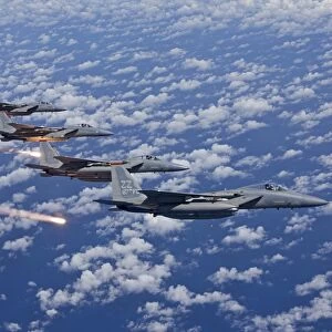 Four F-15 Eagles fly in formation over the Pacific Ocean
