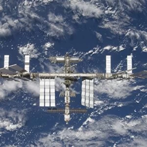 The International Space Station backdropped by a blue and white Earth