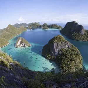 Limestone islands surround a lagoon in a remote part of Raja Ampat