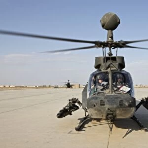 An OH-58D Kiowa helicopter prepares for liftoff from COB Speicher