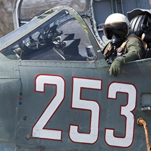 A pilot sitting in the cockpit of a Sukhoi Su-25 aircraft