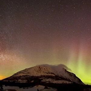 Red aurora borealis and Milky Way over Carcross Desert, Canada