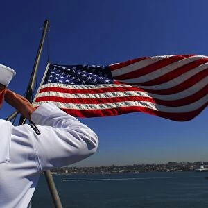 A sailor salutes the American flag