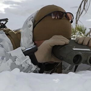 A scout sniper watches to see any position changes in his target