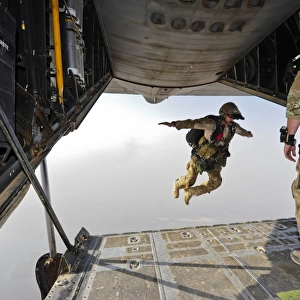 A U. S. Air Force pararescueman jumps out of an HC-130P Combat King aircraft