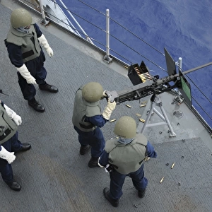 A U. S. Sailor fires a. 50-caliber M2HB machine gun aboard USS Frank Cable