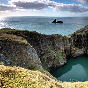 A sink hole, created by collapse of Carboniferous limestone cave roof, Bosherton, Pembrokeshire, Wales, UK. September, 2022
