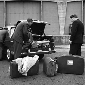 A 1961 Austin Westminster being loaded with luggage on Amsterdam docks, Netherlands 1963