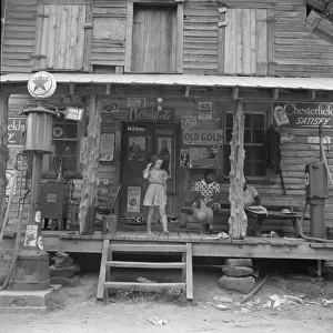 Daughter of white tobacco sharecropper at country store, Person County, North Carolina, 1939. Creator: Dorothea Lange