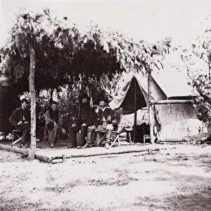 [Four men in camp under a lean-to of pine boughs], 1861-65. Creator: Unknown