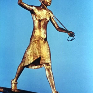 Gold figure of King Tutankhamun standing on a reed boat and spearing fish, 14th century BC