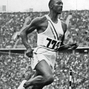 Jesse Owens at the end of the 100m at the Berlin Olympic Games, 1936
