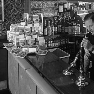 A pub landlord with a display of the Batchelors 5 day catering pack on his bar, 1968