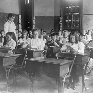 Washington, D.C. public schools, 1st Div. - class making geometric forms with paper, (1899?). Creator: Frances Benjamin Johnston