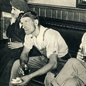 Workmen in an English inn listening to Mr. Churchill, 1942. Creator: Unknown