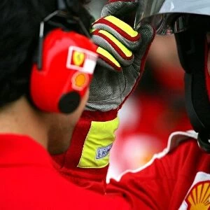 Formula One Testing: Felipe Massa Ferrari talks with a Ferrari mechanic